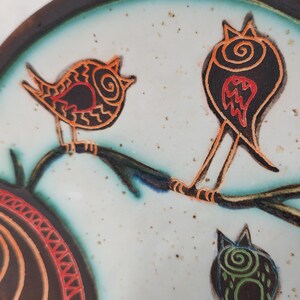 close up detail of handmade ceramic plate with stylized birds design