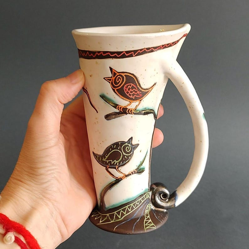 handmade tall ceramic mug bird design coffee cup in hand size view