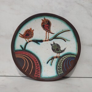 handmade pottery bird plate front view clean background decorative dish