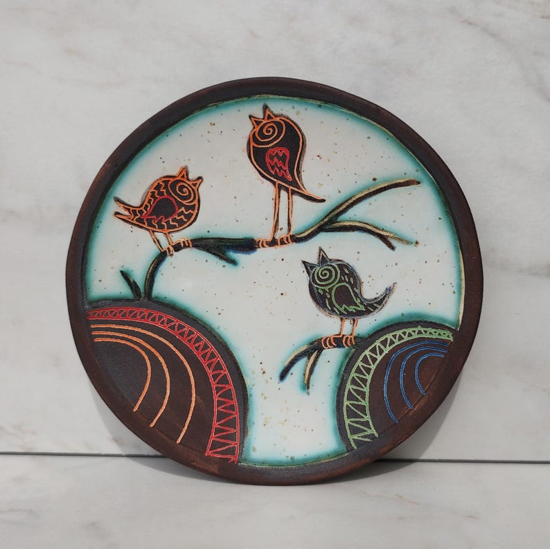 handmade pottery bird plate front view clean background decorative dish