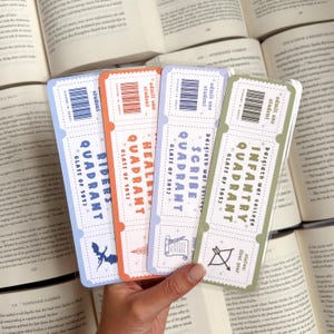 May include: Four colorful bookmarks with a ticket design. Each bookmark features a different quadrant from a fictional school, including "Infantry Quadrant", "Scribe Quadrant", "Healer Quadrant", and "Riders Quadrant". The bookmarks are labeled with the school's name, quadrant, and class year.