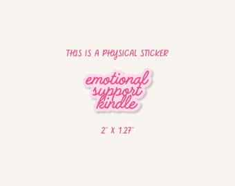 May include: A pink sticker with the words "emotional support kindle" in a cursive font. The sticker is outlined in white and has a light pink background. The text "THIS IS A PHYSICAL STICKER" is above the sticker, and the sticker measures 2" x 1.27".