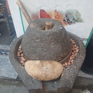 Traditional Moroccan stone grinder used for extracting argan oil, authentic handmade production process