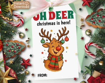 May include: A white gift tag with a cartoon reindeer wearing a scarf and ornaments. The tag reads "OH DEER christmas is here!" in red and green. The tag is surrounded by Christmas decorations, including candy canes and stars.