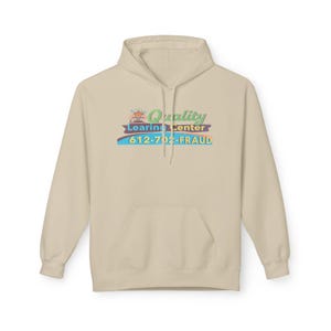 May include: A beige hoodie with a front pocket and a hood. The front of the hoodie features the text "Quality Learning Center" with a phone number and the word "FRAUD" in a colorful design.