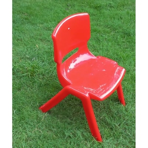 May include: A bright red plastic chair with a simple design. The chair has a slightly curved back and four legs.