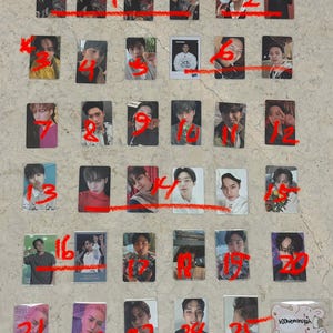 May include: A collection of rectangular photo cards featuring various individuals. The cards are arranged in rows and columns, with each card displaying a different person. The cards are in protective sleeves.