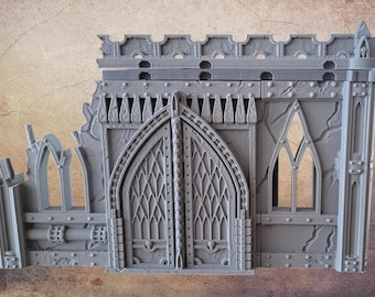May include: A gray, gothic-style miniature building with arched doorways and windows. The model has a textured surface and is designed to look like a weathered structure. The building is likely for tabletop gaming.