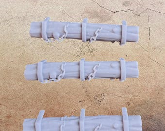May include: Four light gray miniature wooden fence sections with chains and rings. Each section has a textured, wood-like appearance with horizontal bars and vertical supports. The chains are draped across the wooden beams, adding a decorative element.