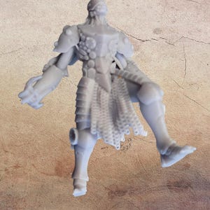 May include: A light gray miniature figurine of a humanoid figure in armor. The figure has detailed armor plating on the shoulders, chest, and legs. A skirt-like chainmail hangs from the waist. The figure is posed with one leg extended and arms outstretched.
