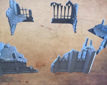 May include: Four pieces of miniature, light blue, ruined building terrain. The pieces are designed to look like sections of a destroyed gothic structure, with broken walls, arches, and architectural details. Ideal for tabletop gaming.