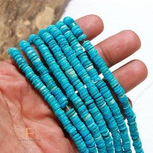 May include: A collection of multiple strands of bright turquoise blue gemstone beads, each shaped like a small, flat disc. The beads are strung together in parallel lines, showcasing a consistent vibrant color with subtle natural variations in texture.