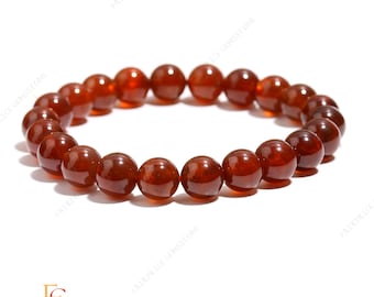May include: A beaded bracelet featuring polished, round, reddish-brown gemstones. The beads are strung together to form a complete circle. The bracelet is displayed on a white surface. The Fairprice Gemstone logo is visible in the bottom left corner.