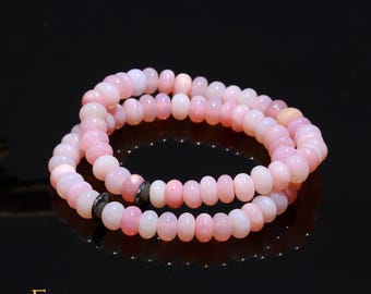 May include: A double strand bracelet made of pink opal beads. The bracelet has a silver clasp.
