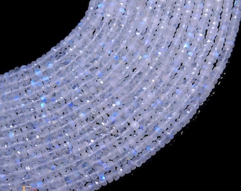 May include: A strand of white moonstone beads, each bead is faceted and has a slight iridescent shimmer. The beads are strung together on a clear thread.