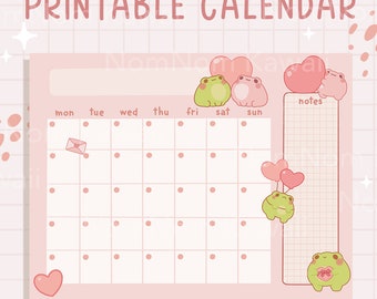 May include: A printable calendar featuring a light pink grid with the text PRINTABLE CALENDAR at the top. The design includes illustrations of small green and pink frogs, pink hearts, and a small envelope icon. A notes section is on the right.