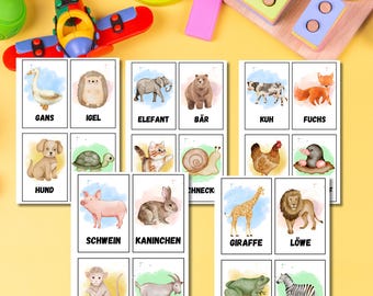 May include: A set of 16 flashcards featuring watercolor illustrations of different animals, each with the German name printed below. The animals include a goose, hedgehog, elephant, bear, cow, fox, dog, snail, pig, rabbit, giraffe, lion, monkey, goat, frog, and zebra.