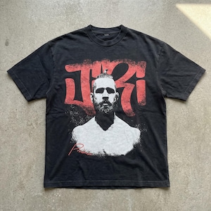 May include: A white ceramic mug with a black handle and the text "But First, Coffee" in a black, handwritten-style font. The mug is on a white surface.