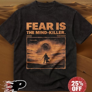 May include: Dark gray t-shirt with the text "FEAR IS THE MIND-KILLER" in orange. The shirt features a graphic from the novel Dune, with the words "ARRAKIS" and "FRANK HERBERT" below the main text. A 25% OFF sticker is visible.