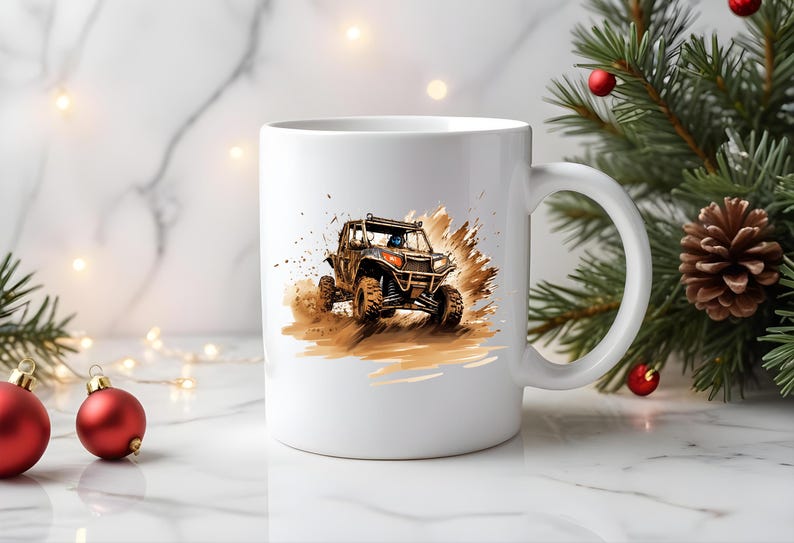 May include: White ceramic mug with a graphic of a brown and black off-road vehicle driving through mud. The vehicle has a black roll cage and a black driver's seat.