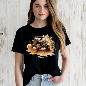 May include: Black t-shirt with a graphic of a brown and black off-road vehicle driving through mud.