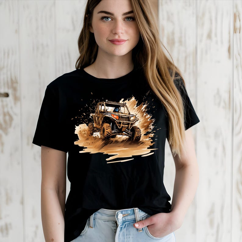 May include: Black t-shirt with a graphic of a brown and black off-road vehicle driving through mud.