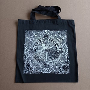May include: Black tote bag with a white design featuring a Celtic knot pattern and the text "Ol' Pocco".