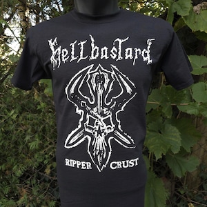 May include: Black t-shirt with a white graphic of a skull with horns and the text "Hellbastard" above it and "Ripper Crust" below it.