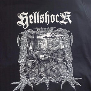 May include: Black t-shirt with a white graphic print of a band logo "Hellshcck" and a detailed illustration of a scene with a dragon and warriors.