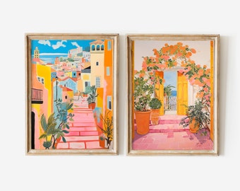 May include: Two framed paintings with a colorful, whimsical style. The first painting shows a pink and yellow staircase leading up to a colorful town with a blue sky and ocean in the background. The second painting shows a yellow door with a pink tiled floor and a lush green plant in a terracotta pot.