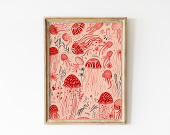 May include: A framed print with a pink background and a repeating pattern of red jellyfish and black seaweed. The print is in a light wood frame.
