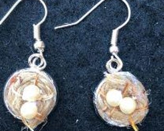 Hand embroidered NEST Earrings with eggs. Jute cord coiled, couched on Aida fabric and glued in bezel earrings.  About 12mm diameter.