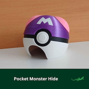 May include: A purple and pink Poke Ball with a white 'M' on the top. The Poke Ball is a toy for kids and is made of plastic.