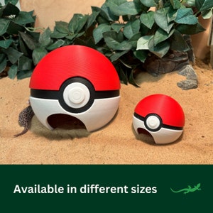 May include: Two red, white, and black Pokeball-shaped reptile hides. The larger hide is about 5 inches in diameter. The smaller hide is about 3 inches in diameter. Both hides have a red top, a black band, and a white bottom.