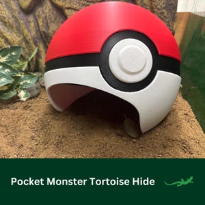 May include: A red, white and black Pokeball-shaped tortoise hide. The hide is made of plastic and has a hole for the tortoise to enter.