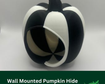 May include: Black and white pumpkin-shaped reptile hide with a hole for entry. Wall mounted.