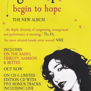 May include: A CD cover for Regina Spektor's album "Begin to Hope" on a yellow background. The album title is in large, bold letters. The cover includes a black and white image of Regina Spektor and album details.