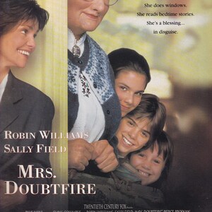May include: Movie poster for "Mrs. Doubtfire" featuring Robin Williams and Sally Field. The poster shows a woman in disguise with children, and the text "She makes dinner. She does windows. She reads bedtime stories. She's a blessing... in disguise."