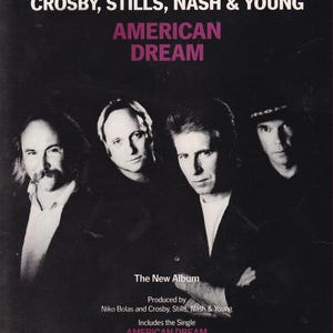 May include: A black and white promotional poster for the Crosby, Stills, Nash & Young album American Dream. The text reads Back Together Again At Last!, Crosby, Stills, Nash & Young, American Dream, The New Album, and includes format details.