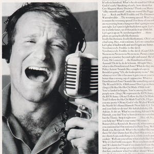 May include: A black and white image of Robin Williams with his mouth open, holding a microphone. The text "Gooood Morning Vi-et-naaaaaaam!!!" is at the top. The image is from the movie "Good Morning, Vietnam."