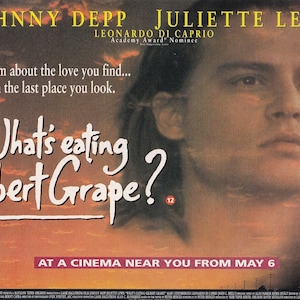 May include: A film poster for What's Eating Gilbert Grape? displaying a large portrait of Johnny Depp set against a sunset sky. The text reads: JOHNNY DEPP, JULIETTE LEWIS, LEONARDO DICAPRIO, A film about the love you find... in the last place you look.