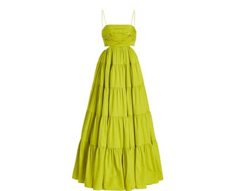 May include: A bright green maxi dress with a cut-out detail at the waist and a tiered skirt.