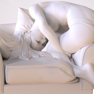 May include: A white sculpture of a person sitting on a white couch with their head resting on a pillow. The sculpture is made of a smooth, white material and is very detailed.