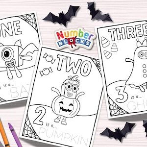 May include: Three black and white Halloween-themed coloring pages with the numbers one, two, and three. Each page features a Numberblocks character dressed as a bat, pumpkin, and ghost. Black paper bats and crayons are scattered around.