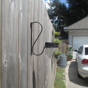 Solar light with metal holder for fence, deck or balcony.