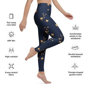 May include: High-waisted navy blue leggings with a gold star pattern. Features include a double-layered waistband, triangle-shaped gusset crotch, and 4-way stretch fabric. The leggings also have a UPF 50+ rating and a tear-away care label.