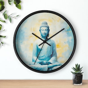 May include: A black wall clock with a blue and yellow watercolor image of a meditating Buddha. The clock hands are black.