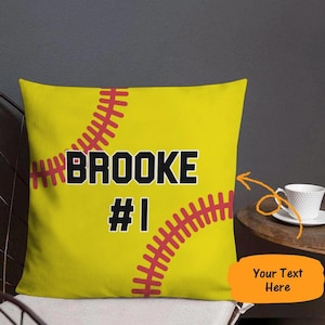 May include: Yellow throw pillow with a red and white softball design. The text "BROOKE #1" is printed on the pillow.