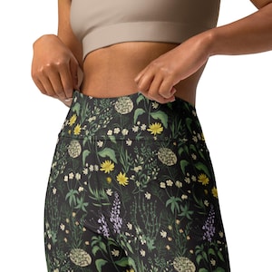 May include: Black leggings with a floral print featuring yellow, green, and white flowers on a dark background.