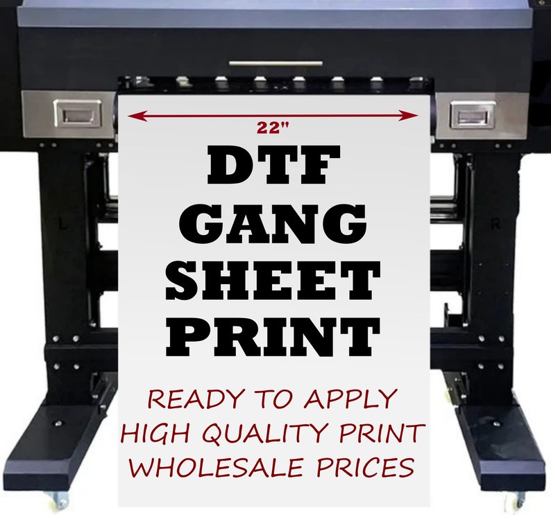 May include: A large black and silver printer with a white sheet of paper in the printer. The paper is 22 inches wide and has the text "DTF GANG SHEET PRINT READY TO APPLY HIGH QUALITY PRINT WHOLESALE PRICES" printed on it.